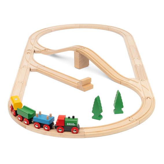Image of the fully put together train set. It comes with four differently colored trains, two wooden trees, and lots of train tracks.