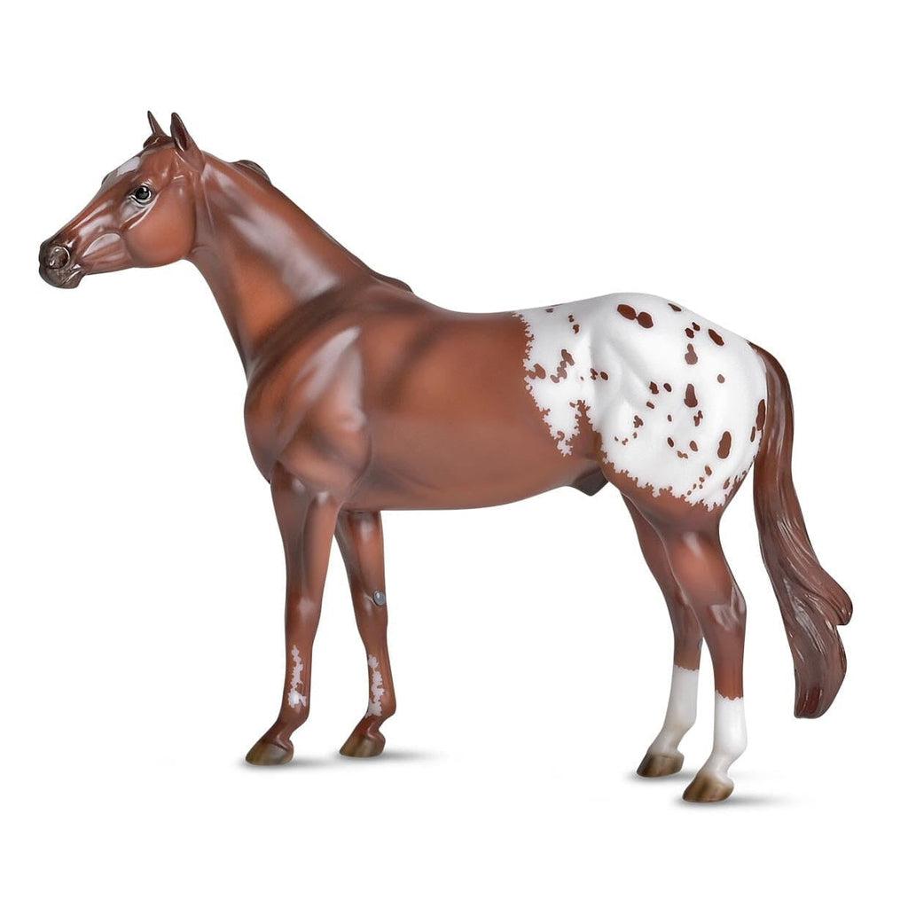 Image of the Appaloosa figurine. It is a red-brown horse with a white flank with brown spots.