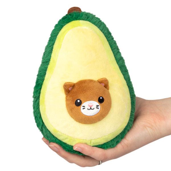 Image of the Avocato squishable. It is a regular avocado plush except the pit is actually a cat face.