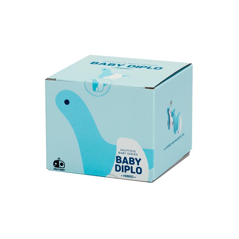Image of the packaging for the Baby Diplo and Crib figurine toy. The box is a light blue cube with a 2D image of the figurine on its side.