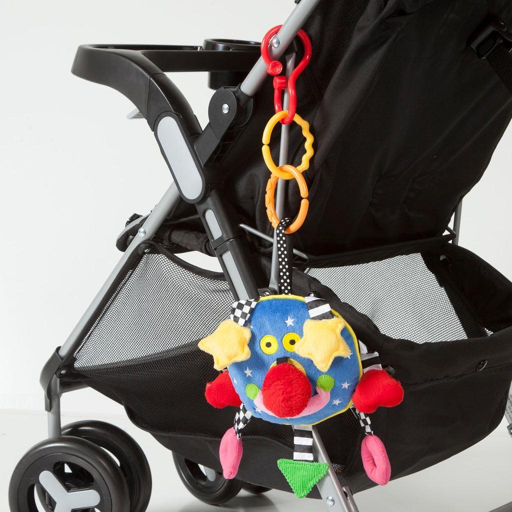 Shows that the Baby Whoozit can hang off of the side of a stroller.
