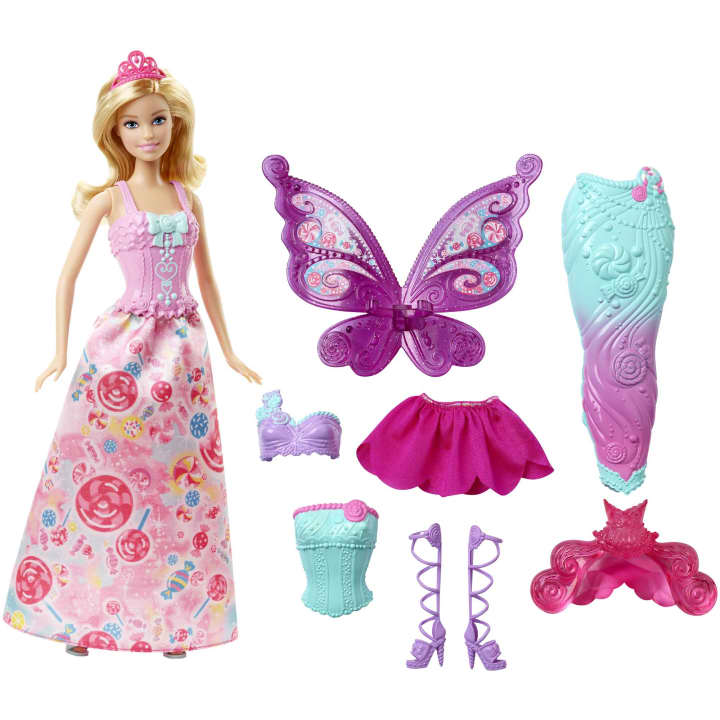 Image of the included pieces. The set includes a Barbie in a pink candy dress, fairy wings, a mermaid tail,, two different bodices, purple ballerina heels, and a pink flower skirt.