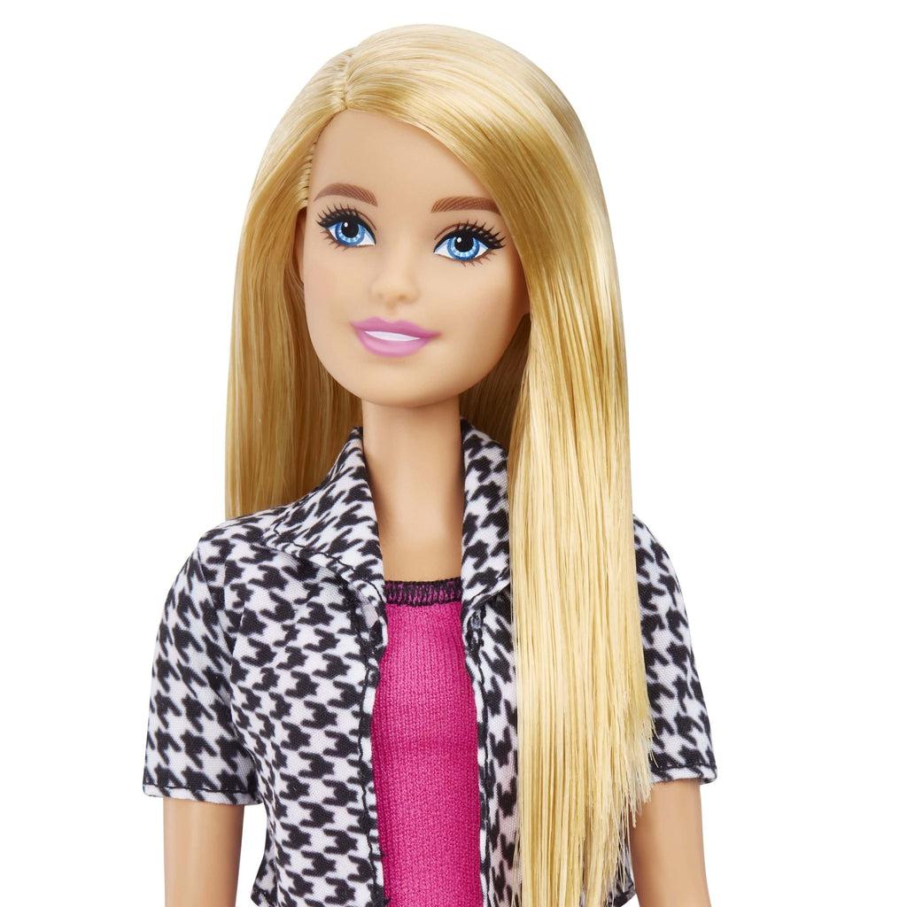 Close up shot of Barbie's face. This Barbie comes with straight blonde hair. She also has blue eyes and natural looking lips.