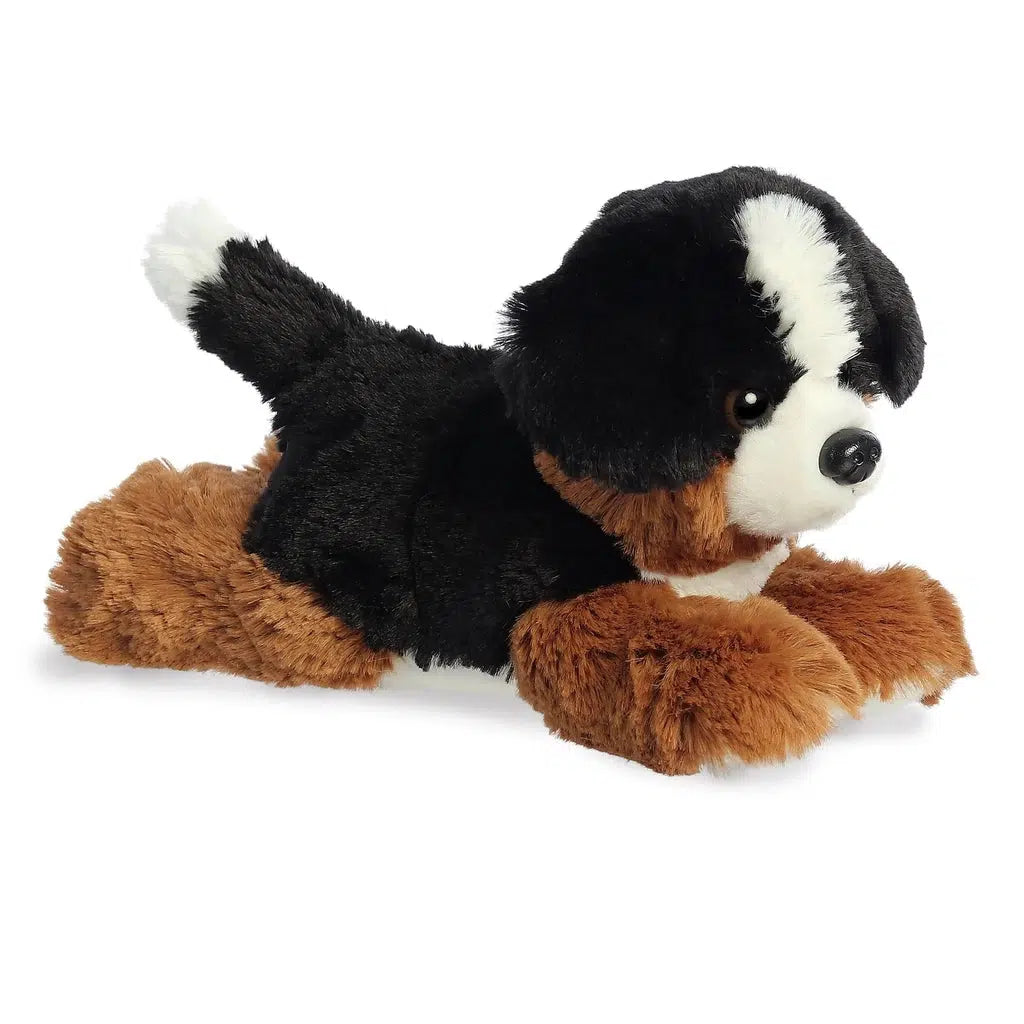 Side view of the dog plush. You can see that his back is black while his legs are primarily brown colored.