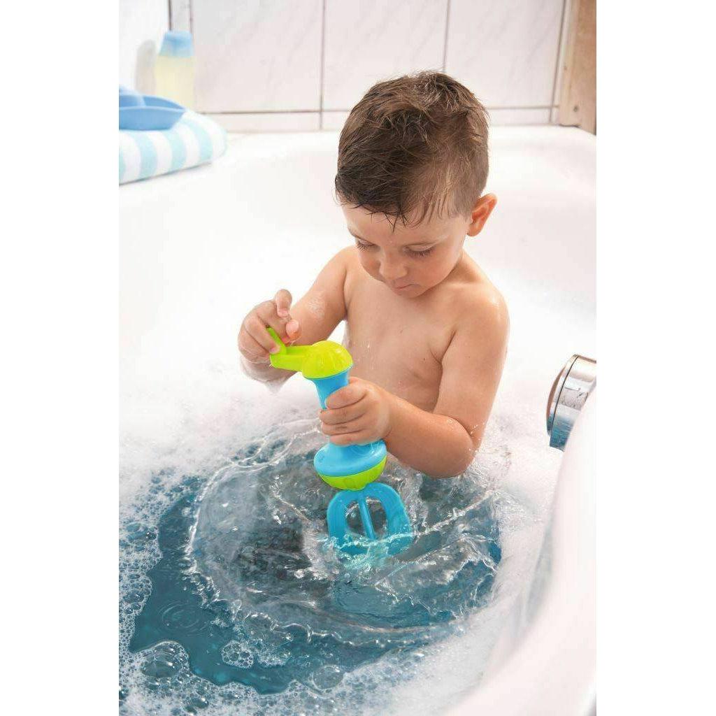 Scene of a little boy using the whisk to make bubbles in his bubble bath.