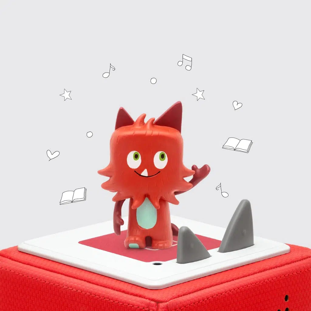 The tonie figure is shown on a toniebox. The figure is a red moster with bushy red hair all over it (hair is still plastic, not actually fuzzy). The monster has a tail and the signature tonie ears