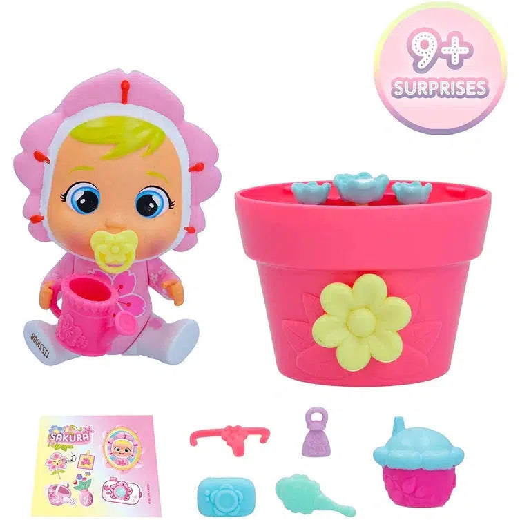 Shows that each blind box comes with 9 surprises. The set includes a flower cry baby, a flower pot, a watering can, a sticker sheet, and various different baby products.