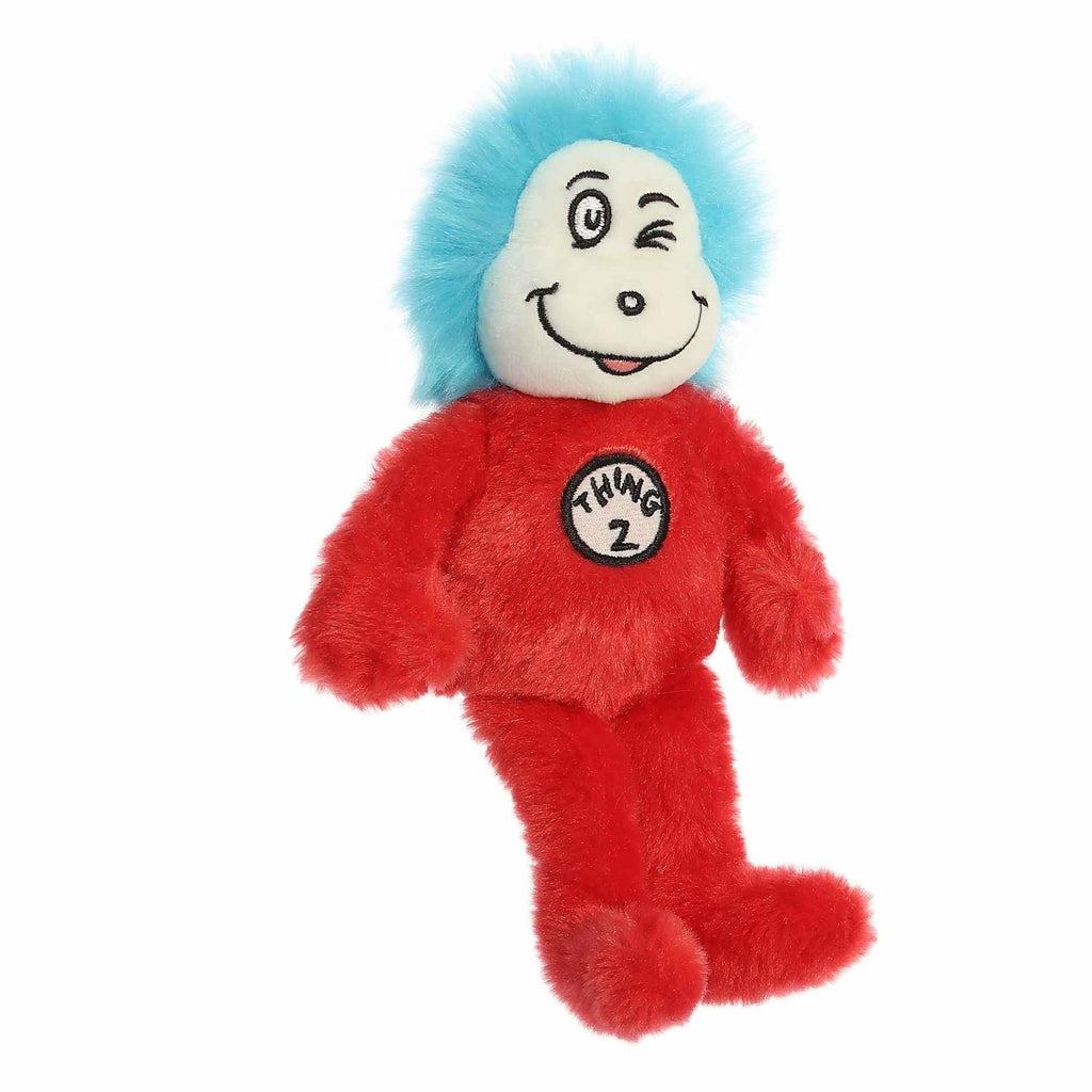 Image of the Dr. Seuss Thing 2 plush. It has a red body, white face, and electric blue hair. On the front of their chest is a sign saying "Thing 2"