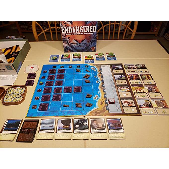 Image of the fully set up game board. The game board has a grid in the ocean as well as a counter on the side. The game comes with lots of cards.