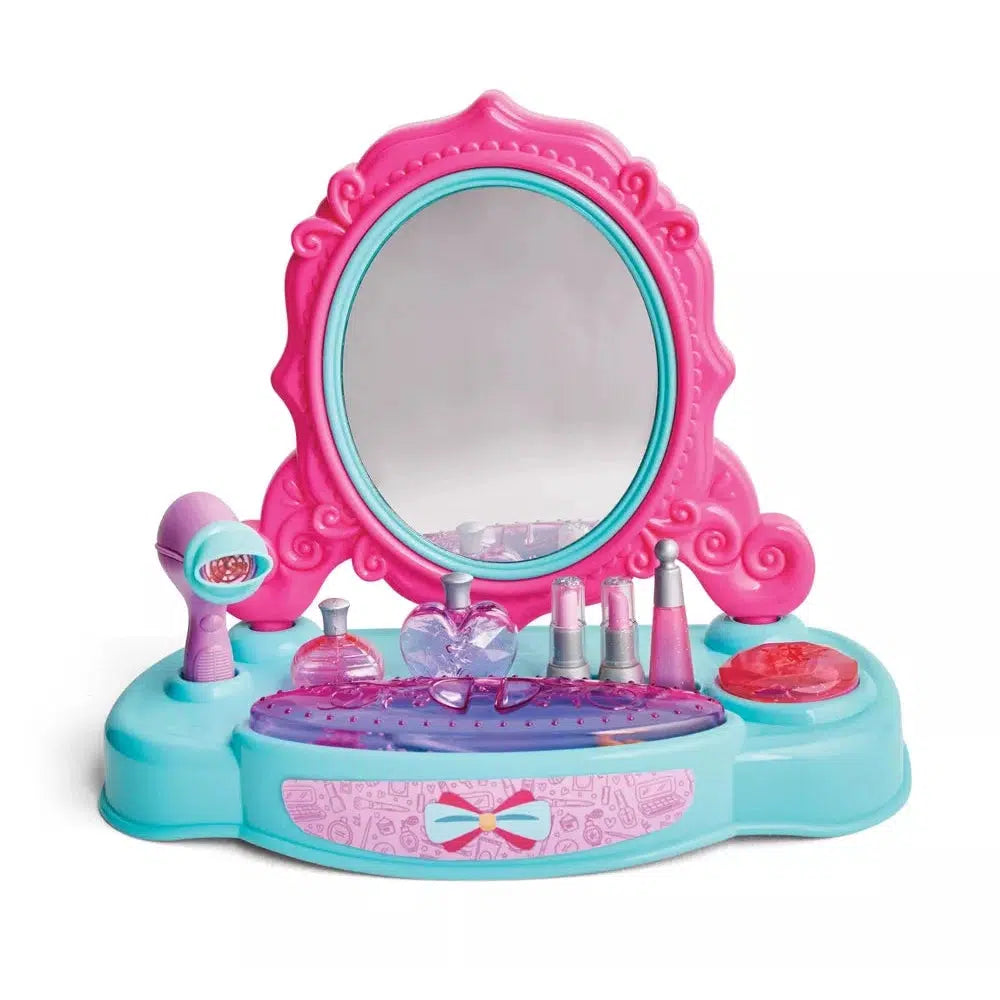 The prop child safe mirror is depicted, with a prop makeup stand. The mirror is pink and decorated so the child can feel like a princess. 