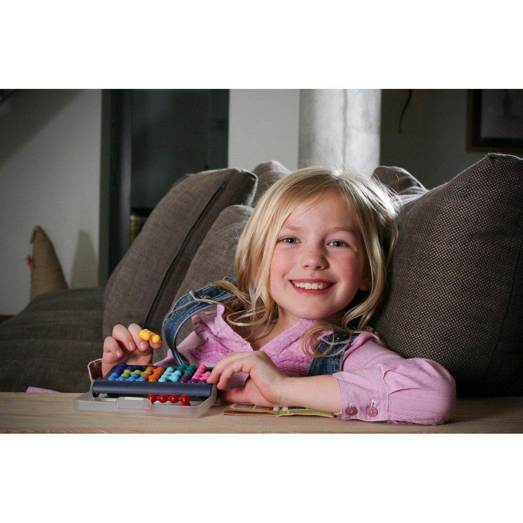 a young girl smiles while playing the game