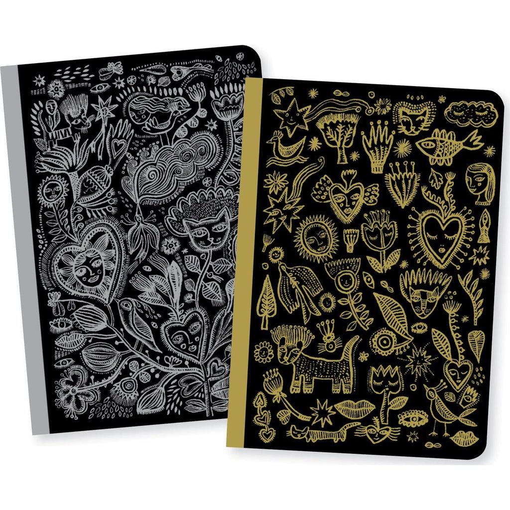 Image of the Little Chic Aurélia Notebook set. Each of them have a black background with designs seemingly scratched into them. One is gold and the other is silver.