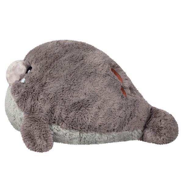 Side view of the plush. Shows that the head is the biggest part of the plush with the tail being the smallest.
