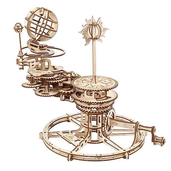 Image of the Mechanical Tellurion model. It is a solar calendar that actually moves with a spinning handle. It has lots of gears and lots of detail to show the Earth, Moon, and Sun all rotating around each other. It is made from unpainted wood.