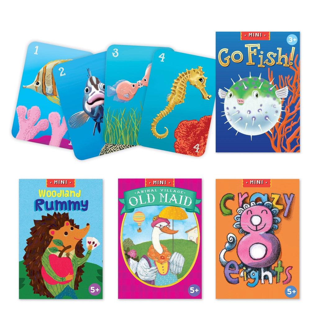 the games Go Fish, Old Maid, Crazy Eights and woodland rummy are lined up. go fish has four cards out of the deck, showing colorful artwork of different fish on each card