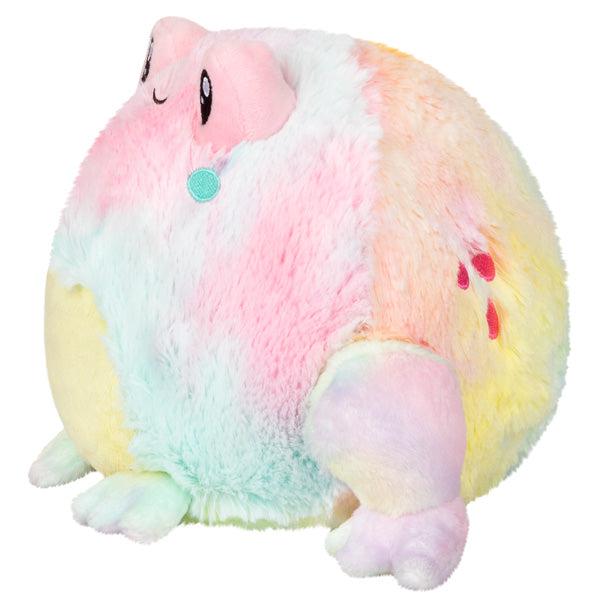 Side view of the plush. Shows that is has large back legs and smaller front legs sticking out of the plush.