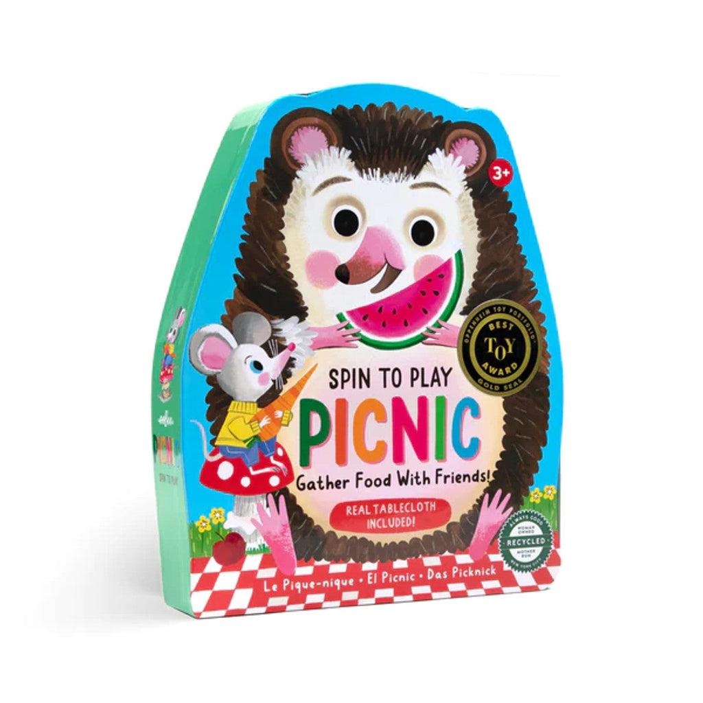 front cover of spin to play picnic. gather food with friends. on the box is a seal that says best toy award. a hedgehog is eating watermelon on the cover next to a mouse eating a carrot 