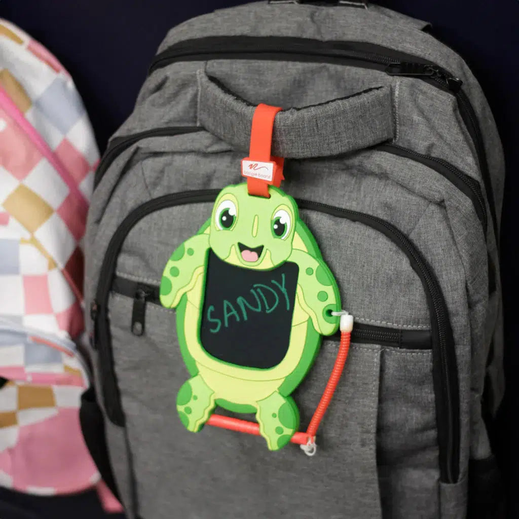 sandy the sea turtle is cliped to a backpack leaving the haters behind.
