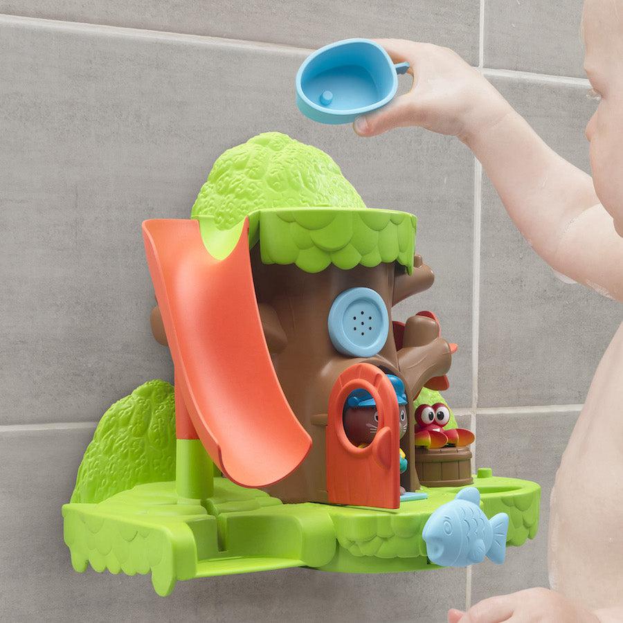 Shows a baby playing with the Bathtub Bay play set. It shows that the bucket at the bottom of the slide is detatchable.