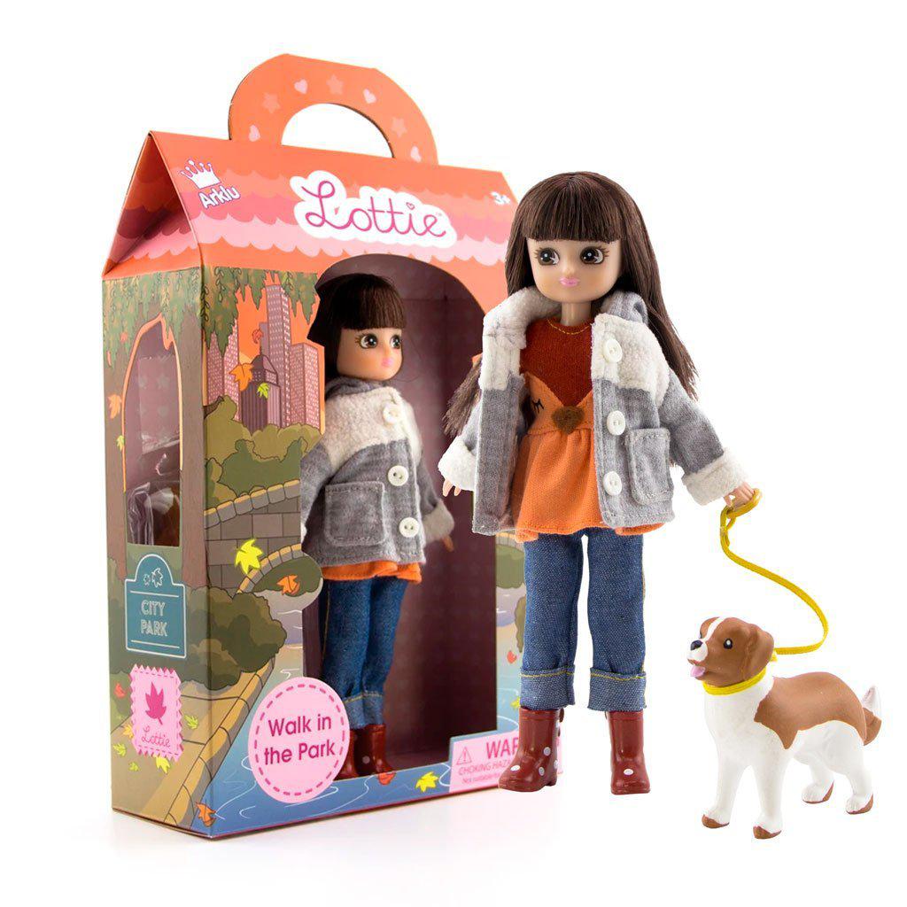 a Lottie doll in a box with a doll dog on a leash
