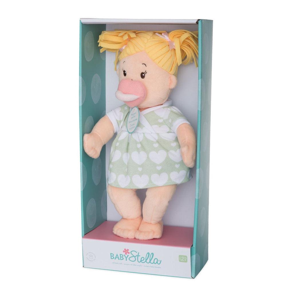 A baby doll is shown in a box that reads: "Baby Stella" at the bottom. The doll is blonde and has a fake pacifier in it's mouth