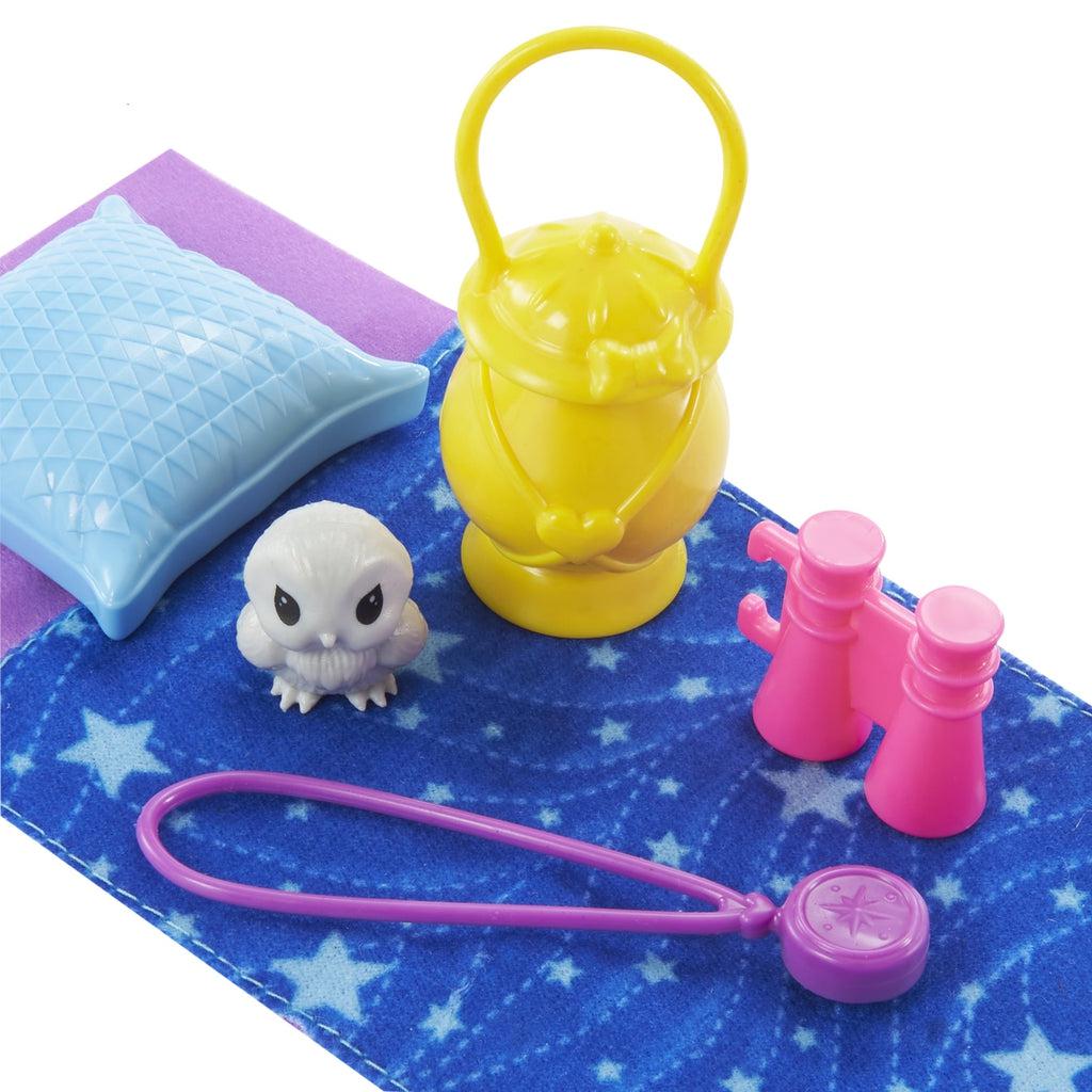 Accessories that come with doll. | Includes a blue sleeping bag with white stars, light blue pillow, yellow lantern, pink binoculars, purple compass necklace, and white baby owl.