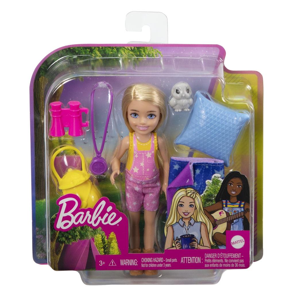 Chelsea camping doll in packaging | Packaging is see-through with an outdoor background behind doll and accessories.
