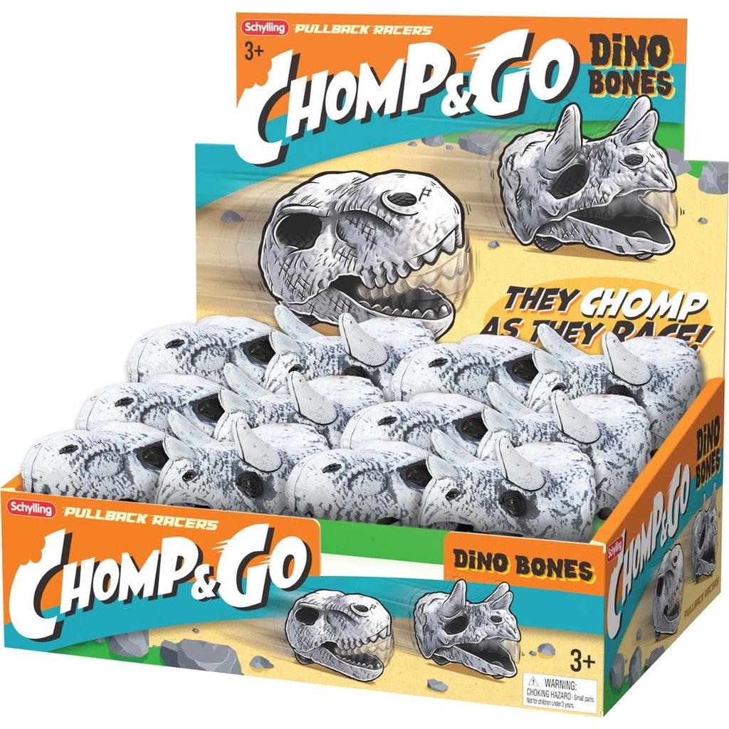 Display box for the product reads: Comp & Go Dino Bones - They chomp as they race. The top left reads Schylling and pullback racers. There is a graphic of the two versions of the pullback cars racing through a desert. The same image and text is repeated on the front an sides of the box and the bottom right of the front has a 3+ and a choking hazard warning.
