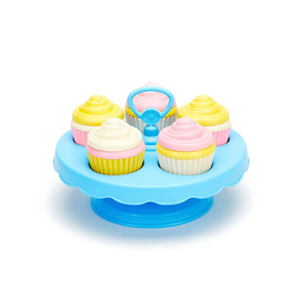 Image of the cupcake set outside of the packaging. The tray is blue and it can hold five cupcakes. The frosting of the cupcakes can be exchanged for different patterns.
