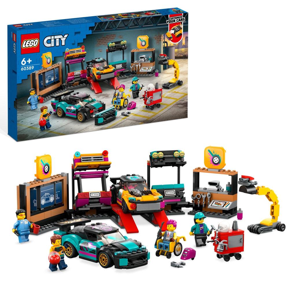 The lego set is shown in front of it's box | There are 2 cars, 4 figures, a design wall and tool wall, and many other lego car parts