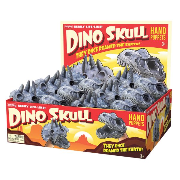 A box is filled with hand puppets in the shape of either t-rex heads or triceratops heads. The box reads Schylling eerily life-like Dino Skull Hand Puppets: They once roamed the earth! The same text is written at the back of the display box and the front of the display box. There is a choking hazard warning at the bottom left of the front of the box, and 3+ in the bottom right.