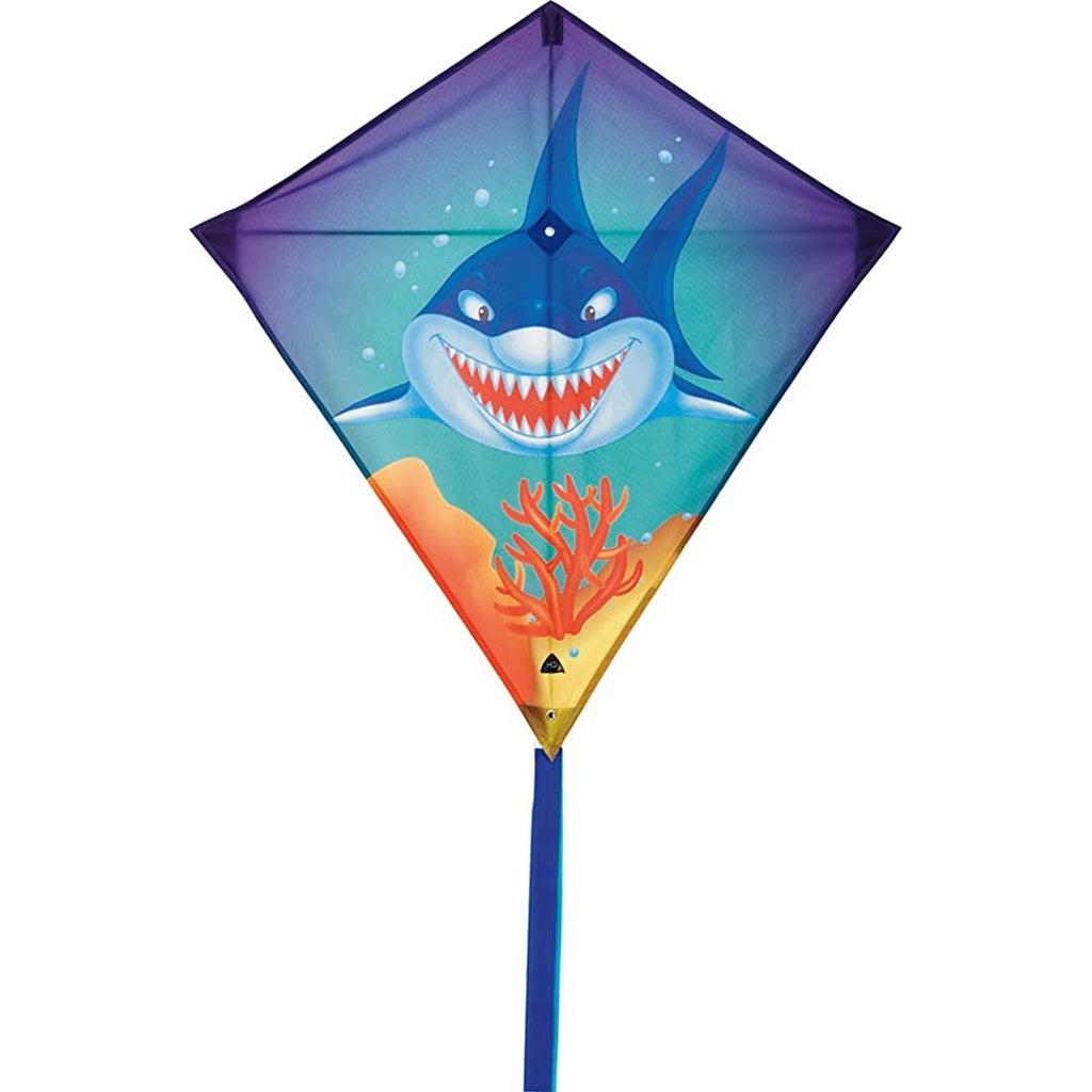 Kite out of package | Kite is diamond shaped and has a graphic of a blue shark with an open mouth facing the viewer. 