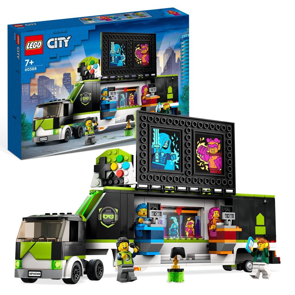 the lego set is shown in front of it's box | There is a black truck with green highlights, it opens up to reveal two lego tournament computers, there are also 4 lego minifigures and a little lego trophy.