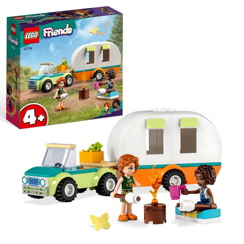 The playset is shown in front of the box, the two lego friends character are in front of a lego campfire in front of their truck and attached camper trailer.