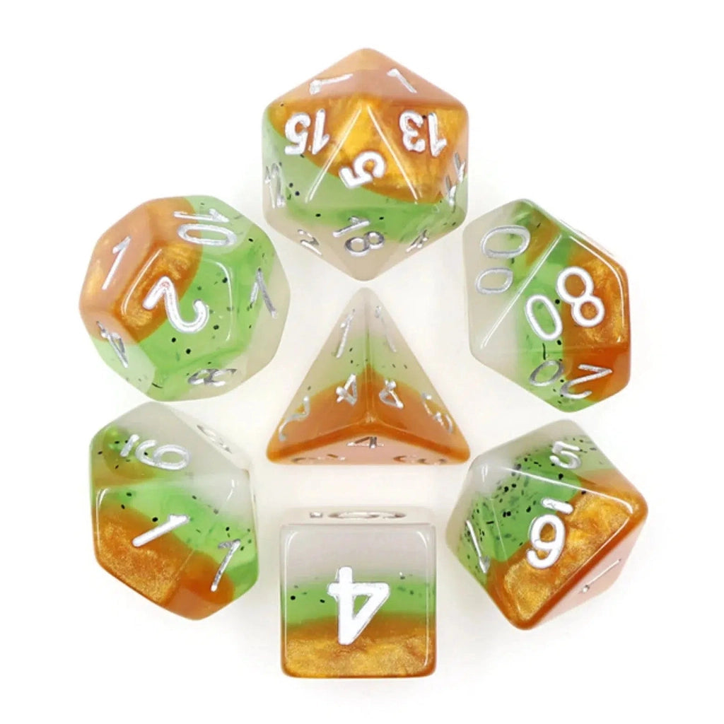 all 7 dice are in a circle with the D4 in the center. Each dice is themed like a kiwi with one end a light brown resin like the skin of a kiwi fruit, and white on the other side like the center of one. The middle sections of the dice are a light green with black specks like seeds spread throughout.
