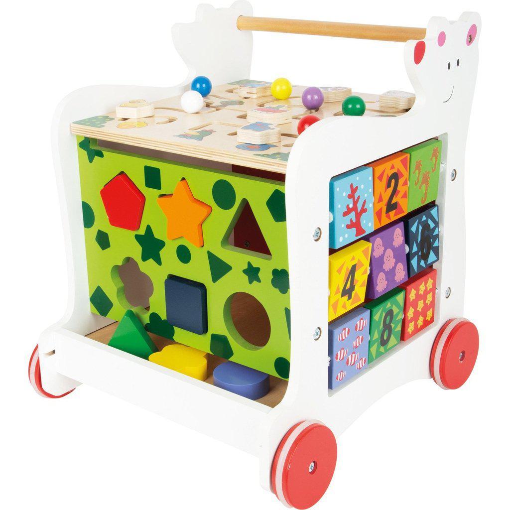 On the front side of the walker is a shape sorting board with a board on the bottom to catch the wooden blocks pushed through.