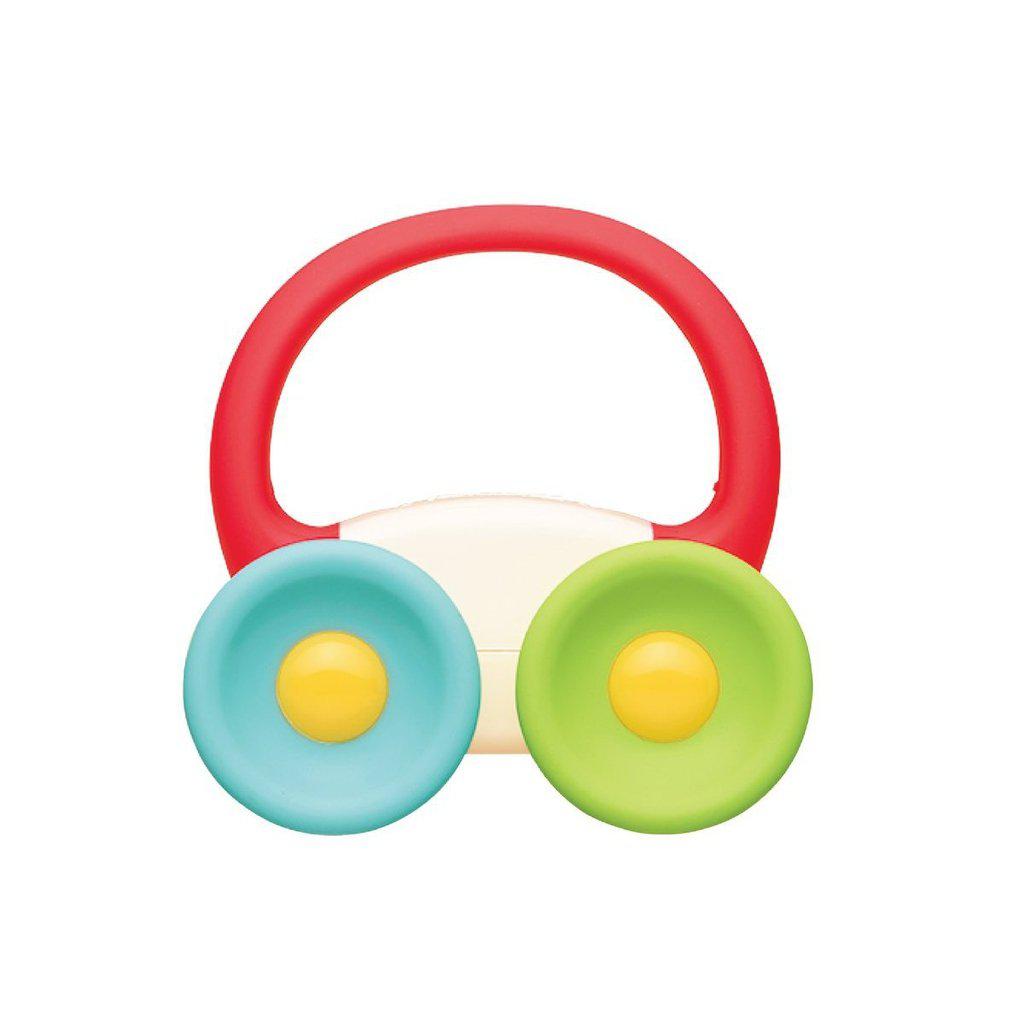 Image of the My First Car Teether. It has a white body, blue and green wheels, and a red handle on top. It is all made of mouth safe rubber material.