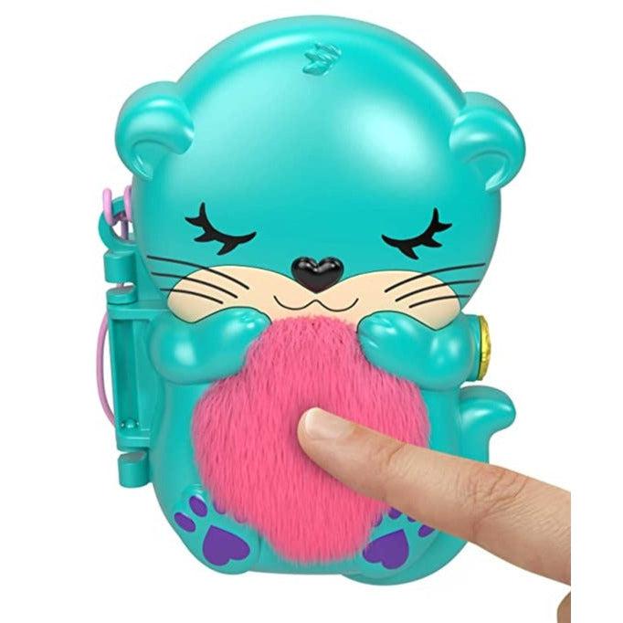Closed compact | Compact is the shape of an otter with a blue body and pink plush stomach | Compact has a purple adjustable strap for travel use.