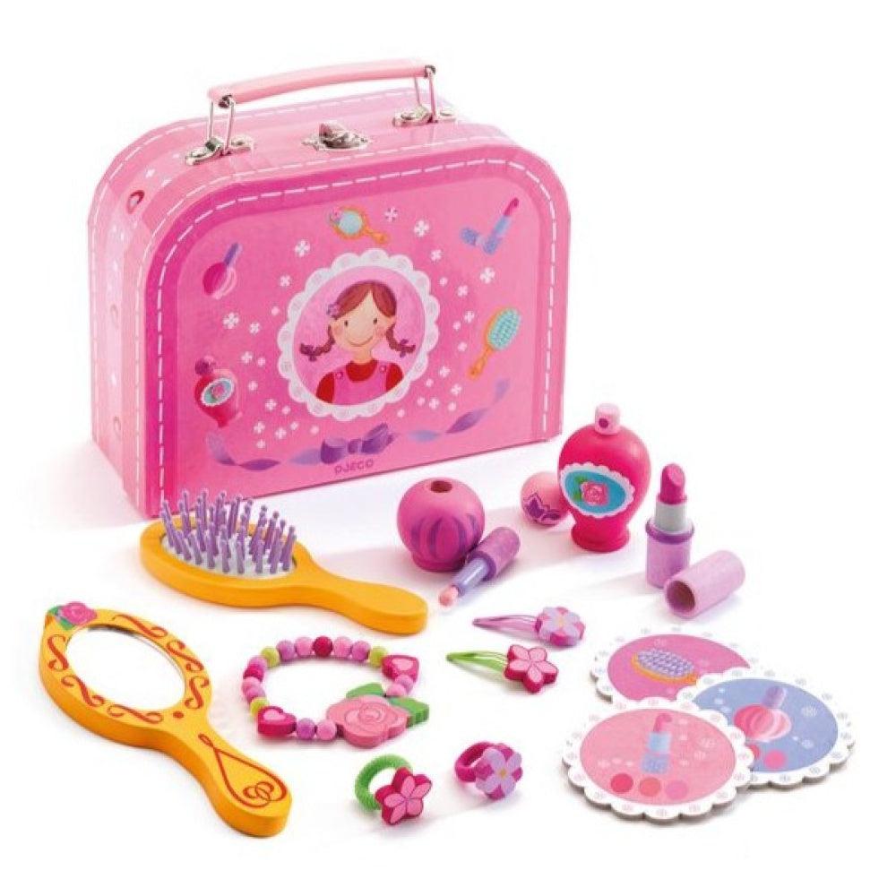 Image of all the included parts in the set. The carrying case is pink with a drawing of a little girl in the center. The set comes with a hairbrush, a mirror, nail polish, perfume, lipstick, and jewelry.