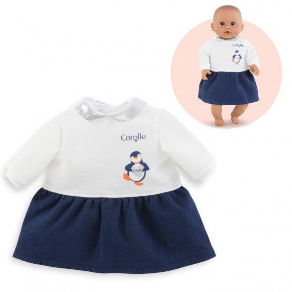 The dress is two parts in one, a white long sleeved shirt attached to a navy blue skirt. The shirt has a penguin holding a heart on the front right of it.