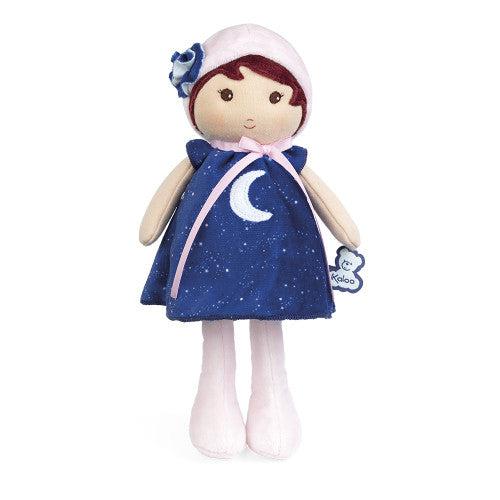 The doll is entirely plush with details sewn into it like the eyes and mouth. The doll is wearing a dark blue dress with stars and a crescent moon sewn into it. The doll also has a pink hat.