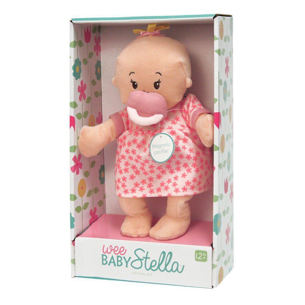 this image shows the peach doll in the wee baby stella line. she is a white baby with yellow heir and a magnetic pacifier.