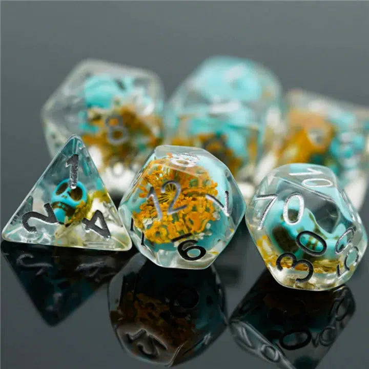 The D4, D12, and percentage D10 are shown,  each is clear resin with a blooming yellow flower and small blue skull inside.