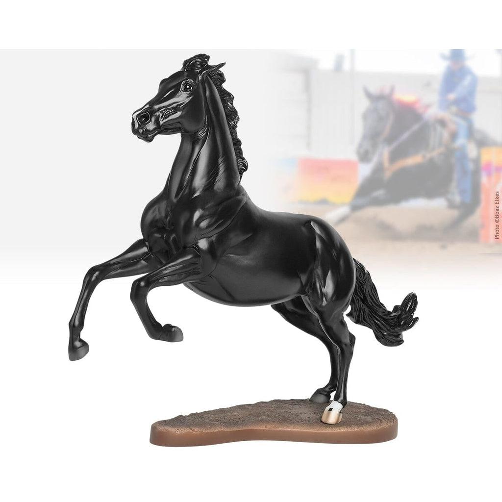 Image of the figurine outside of the packaging. It is a completely black horse from the mane to the tail. It is in a reared back position.