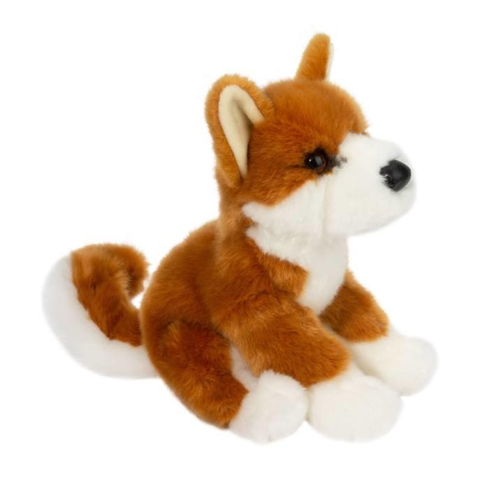 This image shows a side profile of the stuffed animal shiba inu.  the dog is sitting down and has a curled tail