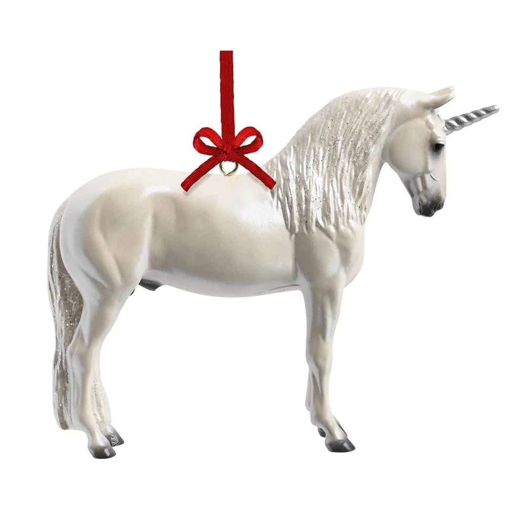 A magical unicorn ornament with a red ribbon.