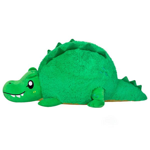Side view of the plush. Shows that the head and the tail stick out from the body.