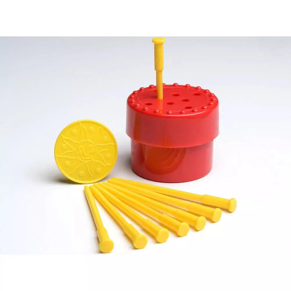 this miage shows a red plactic item that holds some yellow pegs for a magic trick
