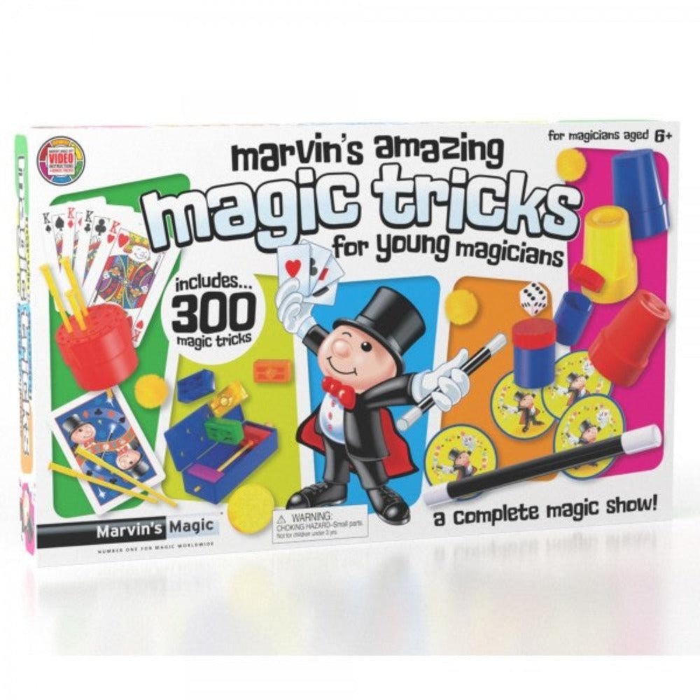 this image shows the box for marvins 300 tricks. there is a complete magic show inside! the image shows several trick items like cups, wands and balls in the background on a wide box