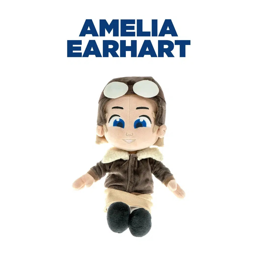 this image shows a plush doll of amelia earhart. she is wearing an aviator hat and goggles on her forehead. 